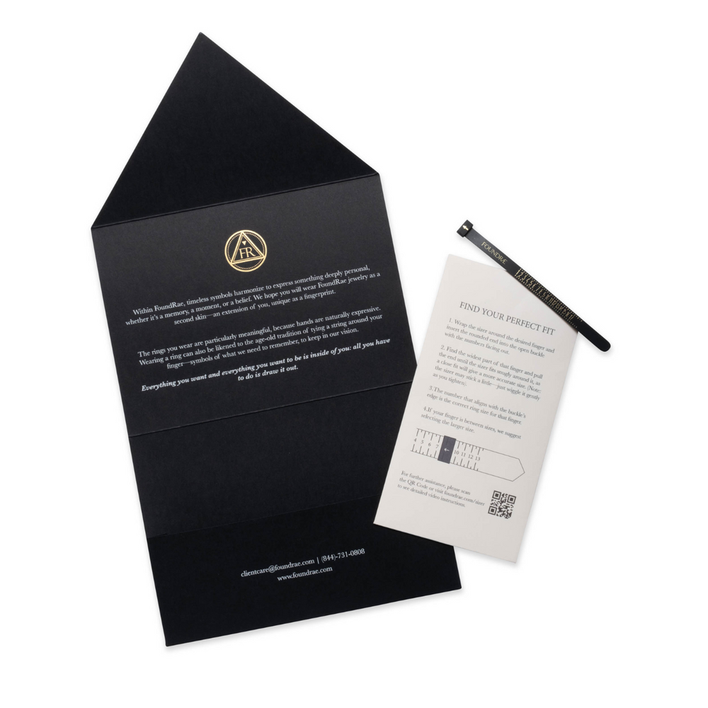Black ring sizer kit with instruction card and sizing strip for measuring ring dimensions.